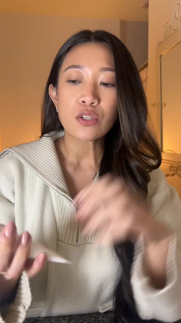 UGC video: woman in a cream knit sweater testing the cream on her hand